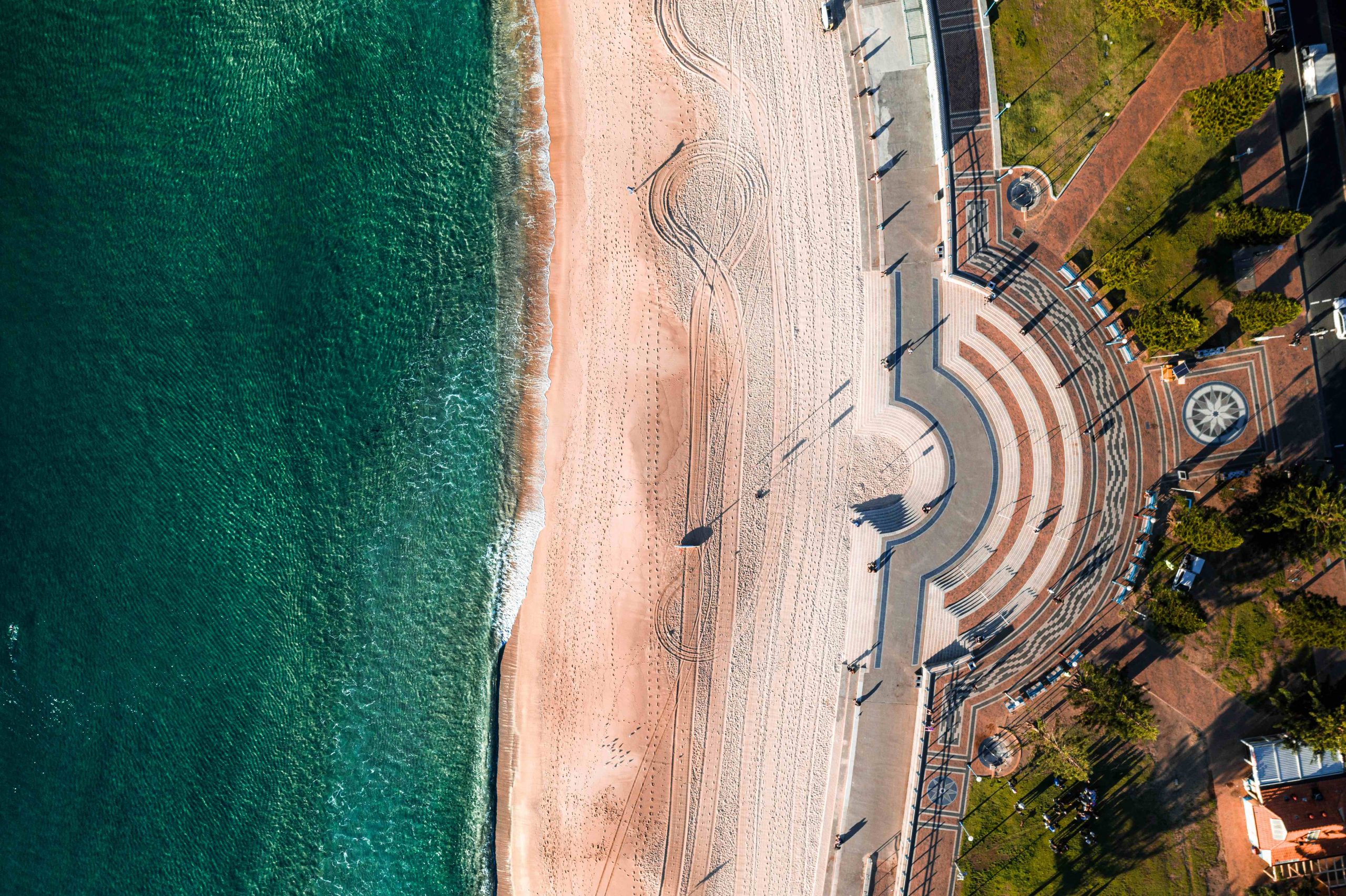 Aerial top down photo of Coogee Beach Sydney at sunrise